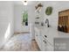 Well-lit laundry room features stylish cabinetry, ample counter space, and brick flooring at 7351 Bay Cove Ct, Denver, NC 28037