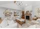 Spacious living room with vaulted ceiling features a brick fireplace, gallery wall, and ample seating at 7351 Bay Cove Ct, Denver, NC 28037