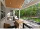 Relaxing screened porch with comfortable seating and views of the wooded backyard at 7351 Bay Cove Ct, Denver, NC 28037