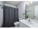 Bathroom features gray shower curtain, a toilet and single sink with a framed mirror and vanity lighting at 741 Bermuda Ave, Gastonia, NC 28054