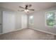Neutral bedroom featuring carpet, a ceiling fan, and a double window allowing natural light to illuminate the space at 741 Bermuda Ave, Gastonia, NC 28054