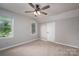 The neutral bedroom features carpet, two windows and is lit by a ceiling fan for comfort at 741 Bermuda Ave, Gastonia, NC 28054