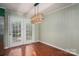 Dining room features stylish light fixture and glass door leading to the exterior at 741 Bermuda Ave, Gastonia, NC 28054