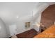 View of open living room featuring a brick fireplace and hardwood floors from an upper vantage point at 741 Bermuda Ave, Gastonia, NC 28054