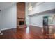 Spacious living room featuring a brick fireplace, vaulted ceilings, and gleaming hardwood floors at 741 Bermuda Ave, Gastonia, NC 28054