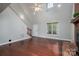 Open living room showcasing hardwood floors, a brick fireplace, and high ceilings with natural light at 741 Bermuda Ave, Gastonia, NC 28054
