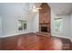 Bright living room with hardwood floors, a brick fireplace, ceiling fan, and natural light from windows at 741 Bermuda Ave, Gastonia, NC 28054
