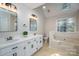 Main bathroom features dual sinks, skylights, garden tub, and a window providing natural light at 741 Bermuda Ave, Gastonia, NC 28054