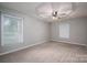Spacious main bedroom features a tray ceiling, ceiling fan, carpet flooring, and natural light at 741 Bermuda Ave, Gastonia, NC 28054