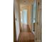 Hallway with view of bathroom and bedrooms, and laminate flooring at 7505 Conifer Cir, Indian Trail, NC 28079