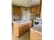 Kitchen featuring wood cabinets, an island, and appliances, ready for upgrades at 7505 Conifer Cir, Indian Trail, NC 28079