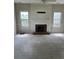 Bright living room featuring a classic fireplace and natural light from windows at 7505 Conifer Cir, Indian Trail, NC 28079
