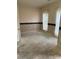 Empty room featuring striped wallpaper, offering potential for customization at 7505 Conifer Cir, Indian Trail, NC 28079