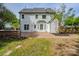 Back exterior of home with brick patio and an outdoor stone grill area, great for outdoor entertaining at 7810 Trotter Rd, Charlotte, NC 28216