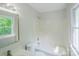 Bright bathroom features a tub-shower combination and a large window, providing natural light at 7810 Trotter Rd, Charlotte, NC 28216