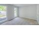 Cozy carpeted bedroom with two windows offering ample natural light and a neutral color palette at 7810 Trotter Rd, Charlotte, NC 28216