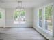 Bright dining room features a modern chandelier, stylish table setting, and large windows at 7810 Trotter Rd, Charlotte, NC 28216