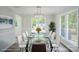 Bright dining room features a modern chandelier, stylish table setting, and large windows at 7810 Trotter Rd, Charlotte, NC 28216