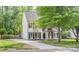 Charming two-story home with black shutters, inviting front porch, and well-manicured lawn at 7810 Trotter Rd, Charlotte, NC 28216