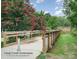Scenic view of the Long Creek Greenway featuring a wooden bridge and lush greenery at 7810 Trotter Rd, Charlotte, NC 28216