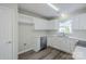 Bright kitchen features white cabinets, stainless steel appliances, and durable laminate flooring for easy maintenance at 7810 Trotter Rd, Charlotte, NC 28216
