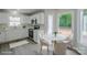 Cozy eat-in kitchen features white cabinets, stainless steel appliances, and charming breakfast nook at 7810 Trotter Rd, Charlotte, NC 28216