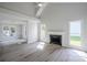 Bright living room with vaulted ceilings, fireplace, hardwood floors, and natural light at 7810 Trotter Rd, Charlotte, NC 28216