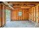 Interior view of unfinished storage shed with wood paneling, small window and exterior door at 7810 Trotter Rd, Charlotte, NC 28216