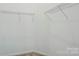 Unfinished walk-in closet with wire shelving, carpeted floor and ample room for storage at 7810 Trotter Rd, Charlotte, NC 28216