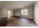Open living room area with hardwood floors, neutral walls, and bright light from the windows at 8 Bolt Dr, Shelby, NC 28150