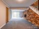 Spacious open basement with a brick fireplace and sliding glass doors at 910 Surry Dr, Shelby, NC 28152