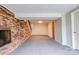 Large open basement featuring brick fireplace and doorway to an additional space at 910 Surry Dr, Shelby, NC 28152