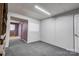 Partially finished basement with carpeted floors and a white board, offering versatile space at 910 Surry Dr, Shelby, NC 28152