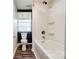 Modern bathroom features a shower over tub, toilet, and window at 910 Surry Dr, Shelby, NC 28152