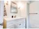 Bright bathroom featuring a modern vanity with a white countertop, stylish fixtures, and a framed mirror at 910 Surry Dr, Shelby, NC 28152