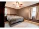 Bedroom with plush blanket on bed, a ceiling fan, and two windows with curtains at 910 Surry Dr, Shelby, NC 28152