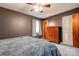 Bedroom with plush blanket on bed, wood dresser, window, and ceiling fan at 910 Surry Dr, Shelby, NC 28152