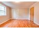 Neutral bedroom featuring hardwood floors, a window, and closet doors at 910 Surry Dr, Shelby, NC 28152