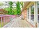 Spacious wooden deck with a pink railing, chairs, and views of surrounding trees at 910 Surry Dr, Shelby, NC 28152