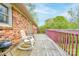 Exterior of a home with a wooden deck featuring a grill and chairs with views of the surrounding landscape at 910 Surry Dr, Shelby, NC 28152