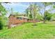 Charming brick home with a well-manicured lawn, mature trees, and inviting curb appeal at 910 Surry Dr, Shelby, NC 28152