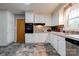 Well-lit kitchen with white cabinets, stainless steel appliances and a gray backsplash and floor at 910 Surry Dr, Shelby, NC 28152
