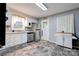 Bright kitchen with stainless steel appliances, white cabinets, tile backsplash, and a neutral colored floor at 910 Surry Dr, Shelby, NC 28152