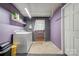 Functional laundry room featuring a washer, shelving, and a door for easy access at 910 Surry Dr, Shelby, NC 28152