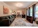 Comfortable living room featuring a large rug, couch, decorative shelving, and plenty of natural light at 910 Surry Dr, Shelby, NC 28152