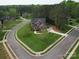 Aerial view of a two-story home on a large corner lot with mature trees and landscaping at 914 Olive Mill Ln, Matthews, NC 28104