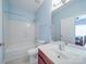 Clean bathroom featuring a shower-tub combo, wood cabinets, and a framed mirror at 914 Olive Mill Ln, Matthews, NC 28104