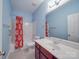 Bright bathroom with vanity sink, red patterned shower curtain and large mirror at 914 Olive Mill Ln, Matthews, NC 28104