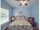 Cozy bedroom with comfortable bed, ceiling fan, and natural light from the window at 914 Olive Mill Ln, Matthews, NC 28104