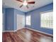 Bedroom featuring hardwood floors, a ceiling fan, and two windows at 914 Olive Mill Ln, Matthews, NC 28104